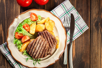 Succulent portions of grilled fillet mignon served with baked po