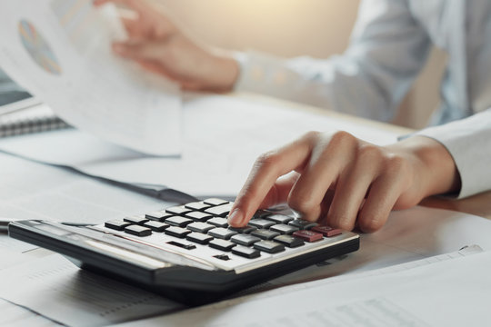 businessman using calculator for calculate budget on table in office. concept finance and accounting