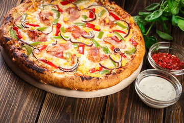 Homemade pizza with bacon, paprika and corn