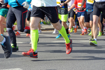 Marathon running race, many runners feet on road, sport, fitness and healthy lifestyle concept
