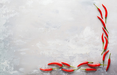 Red chili peppers on gray concrete background. Food frame. Top view, copy space