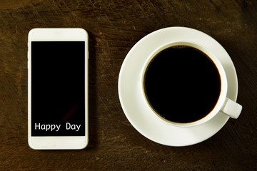 cup of coffee and smartphone on the wood