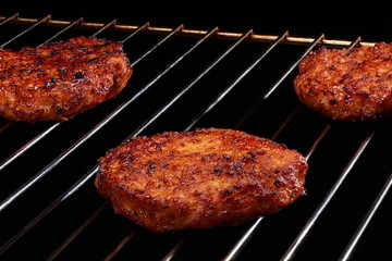 Delicious hamburgers cooking on grill