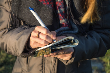 Note taking and brainstorming outdoors, close-up.