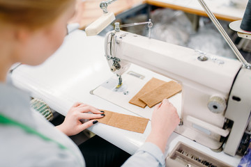 Dressmaker sews fabrics on a sewing machine