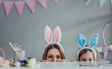 Mom and daughter preparing for Easter celebration