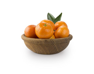 Mandarins in a wooden bowl with copy space for text. Ripe and tasty tangerines isolated on white. Clementines on a white background. Background tangerines.