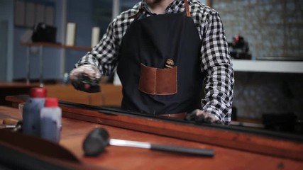 Leather handbag craftsman at work in a workshop
