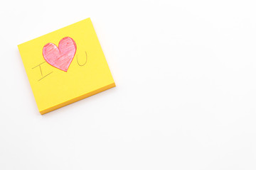 Paper red heart on Yellow Post-it note with White Pastel plastic texture background. Valentine concept. Minimal concept