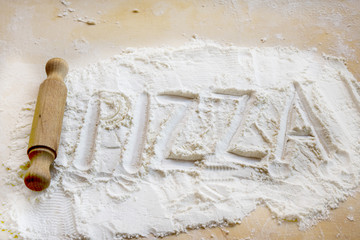 concept of pizza with the writthen on the flour