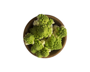 Roman cauliflower in wooden bowl isolated on white background. Roman cauliflower close up. Fractal texture of romanesco broccoli. Roman cauliflower with copy space for text. Top view