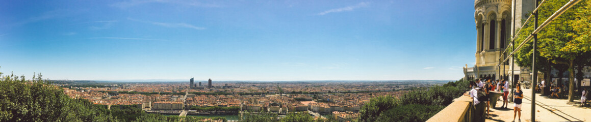 Fototapeta na wymiar Huge wide Panorama summer view of the city, Lyon, France. With colorful blue sky and white clouds.