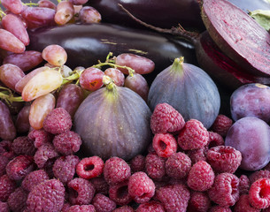 Purple food. Background of berries, fruits and vegetables.  Fresh figs, plums, raspberries, beet, eggplant and grapes. Top view