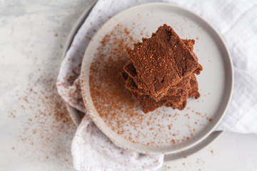 A stack of slices of healthy vegan brownies. Healthy dietary vegan dessert concept. Top view, copy space.