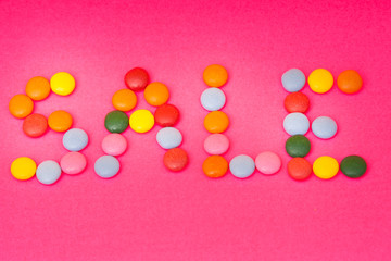 Word SALE made from colored glaze dragee 