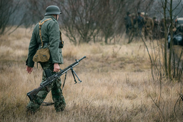 German soldier with a machine gun in the field