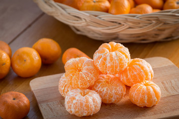 fresh mandarin oranges fruit with leaves on wooden table

