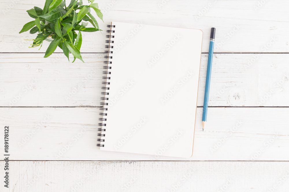 Wall mural empty open notebook on white wood table top view