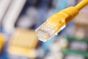 close-up view of  ethernet cable on blurred motherboard background
