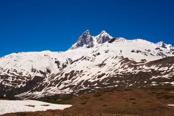 Fototapeta na wymiar Severe rocky peaks of Ushba