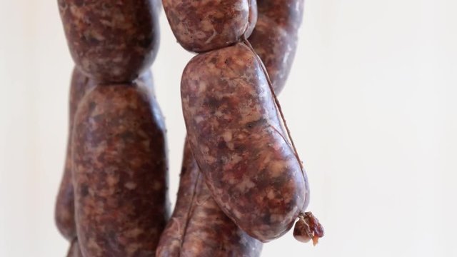 Traditional Italian sausages hanging at butcher meat market