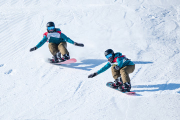 People are having fun in downhill skiing and snowboarding	