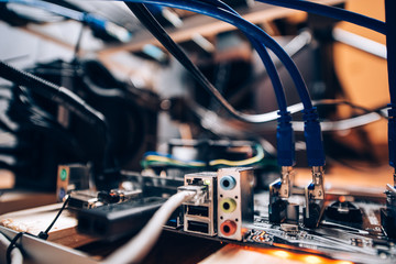 Close up details of mining rig, graphics cards cables and motherboard and network connecton. Modern technology used for mining bitcoin, ethereum and other alt coins