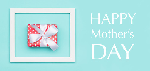 Happy Mother's Day Pastel Blue Candy Colour Background. Mothers day flat lay minimal web banner with beautifully wrapped present.