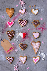 top view of sweet traditional heart shaped cookies with love tag on grey cracked surface