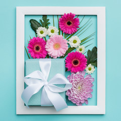 Happy Mother's Day, Women's Day, Valentine's Day or Birthday Pastel Candy Colors Background. Floral flat lay minimal concept with beautifully wrapped present.