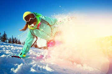 Snowboarder on snowboard rides through snow, explosion. Freeride snowboarding in Sheregesh Ski...