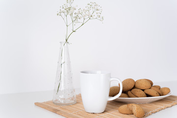 Mug and cookies on table