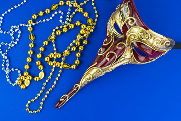 Carnival elegant male venetian  mask and beads.