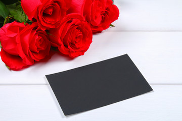 Pink roses with a blank chalkboard for text. Copy space for text. Template for March 8, Mother's Day, Valentine's Day.