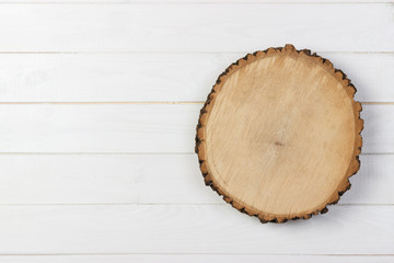 Wood plank board on wooden table. Top view with copy space