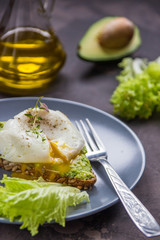 Sandwich with avocado and poached egg. Healthy breakfast