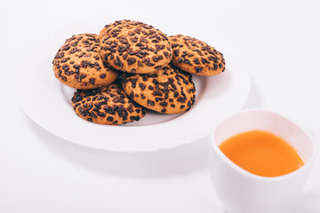 Cup with fruit juice and cookies