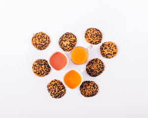 A lot of cookies and glasses of juice