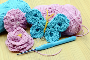 crocheting butterfly with crochet hook and wool.
