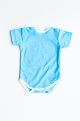 Baby clothes. Blue bodysuit for little boy on white background top view