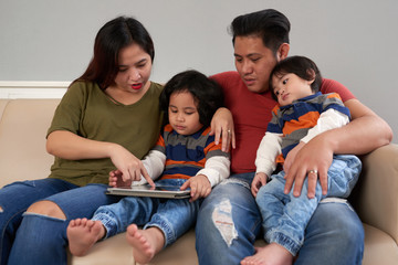 Family with tablet computer