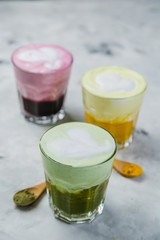 Selection of colorful super lattes on marble background