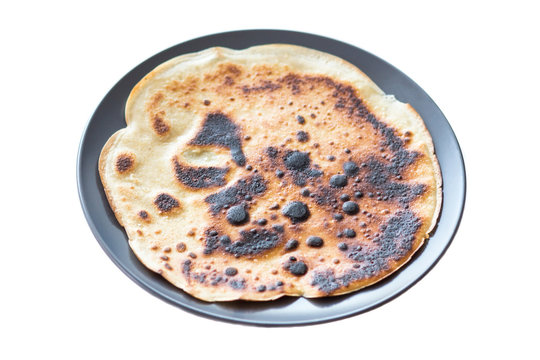 Burnt Pancake Presented On A Plate, Isolated