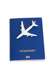 Small plane on top of blue passports, isolated, top view