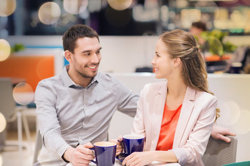 happy couple with shopping bags drinking coffee