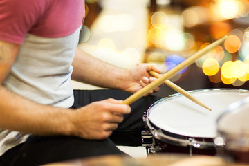 close up of musician or drummer playing drum kit