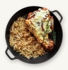 Pork knuckle with braised cabbage in saucepan isolated at white