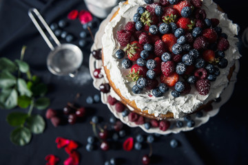 Beautiful, fruit naked cake on a dark tablecloth 
