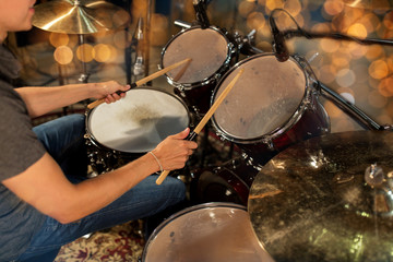Fototapeta na wymiar male musician playing drum kit at concert