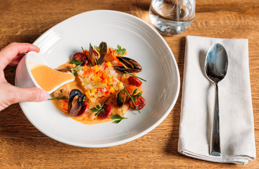 Fish soup with mussels, aniseed sauce and vegetables